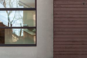 exterior,view,of,residential,facade,with,large,window,revealing,interior